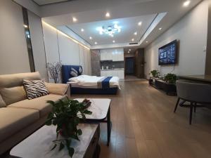 a large living room with a bed and a couch at Anda Guesthouse in Hohhot