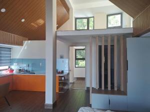 a kitchen with orange cabinets and blue walls at Khách Sạn The Pine Scent in Da Lat
