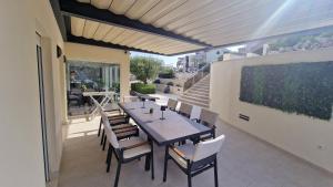a patio with a table and chairs on a balcony at Villa Gina in Sevid