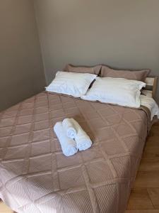 a bed with two towels on top of it at Посуточно 1 комнатная Драмтеатр, ЖК Park city, Green Leaf, Noviy Bereg, ТЦ MAXI MALL in Ustʼ-Kamenogorsk