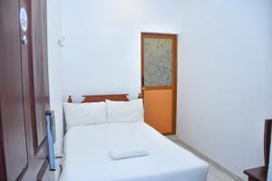 Postel nebo postele na pokoji v ubytování Ez Stay Guesthouse