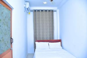Postel nebo postele na pokoji v ubytování Ez Stay Guesthouse