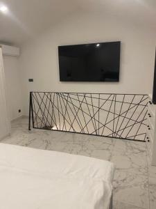 a flat screen tv on a wall above a bed at Luxury Apartman Anđela in Banjol +10 photos