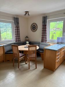 a living room with a table and chairs and a couch at Ferienhaus Rotenbichler in Schladming
