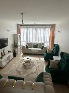 ナイロビにあるJKIA homestaysのリビングルーム(ソファ、ソファ、テーブル付)