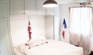 1 dormitorio con 1 cama con banderas en la pared en Between the dunes and the sea, en Les Moitiers-dʼAllonne