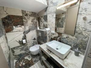 a bathroom with a sink and a toilet at Kelevi Seaside Apartment in Nikiti