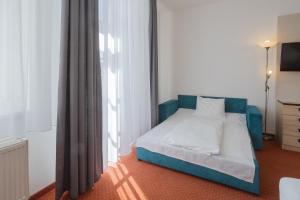 Postel nebo postele na pokoji v ubytování Hotel Flora