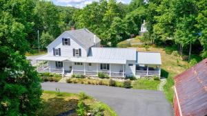 an aerial view of a white house with a driveway at New Lovely Vermont Hamlet Home near Rock River in Newfane
