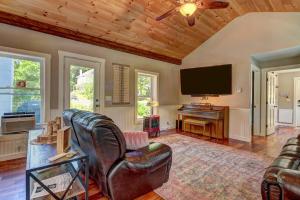a living room with leather furniture and a flat screen tv at New Lovely Vermont Hamlet Home near Rock River in Newfane