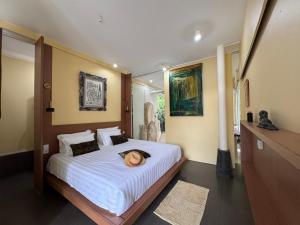 a woman laying on a bed in a bedroom at BATI Private Living in Ubud