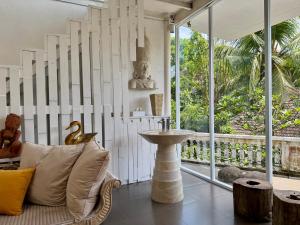 a living room with a couch and a sink at BATI Private Living in Ubud