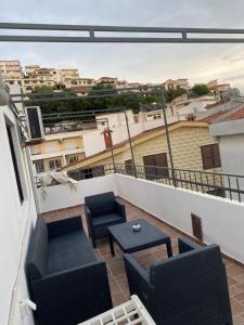 a balcony with chairs and a table on a building at Casa del Mare in Ulcinj