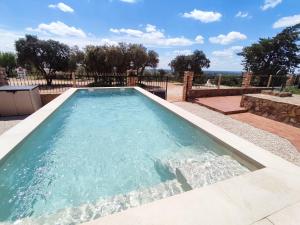 a swimming pool with water in the middle at VILLA CERRO MORENOVilla privada con piscina en finca exclusiva a 10 min de Lagunas de Ruidera in Ossa de Montiel