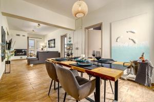 a living room with a table and chairs at Gorgeous penthouse in Vari with panoramic views! in Vari