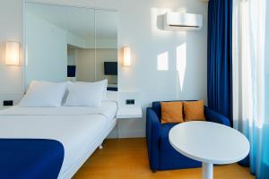 A bed or beds in a room at DOWNTOWN Centre in Batumi Aparthotel Orbi City N1