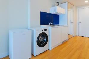 A kitchen or kitchenette at DOWNTOWN Centre in Batumi Aparthotel Orbi City N1