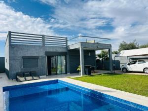 a house with a swimming pool next to a car at Villa Naouma in Marrakesh