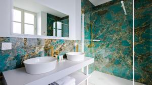 a bathroom with two sinks and a mirror at Solstice Beaune - Hôtel et Terroir in Beaune +50 photos