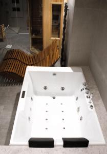 a white bath tub sitting in a room at Villa Stesicoro Suite in Mondello