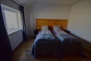 A bed or beds in a room at Glacier World - Hoffell Guesthouse