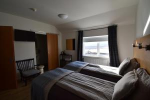 A bed or beds in a room at Glacier World - Hoffell Guesthouse