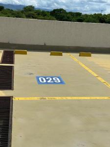 a parking lot with a sign on the floor at Casamora girardot in Estación El Salto