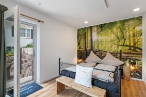 a bedroom with a bed and a painting on the wall at Urlaub Schwarzwaldliebe in Bad Teinach-Zavelstein