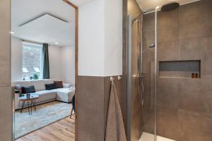 a bathroom with a shower with a glass door at Urlaub Schwarzwaldliebe in Bad Teinach-Zavelstein +17 photos