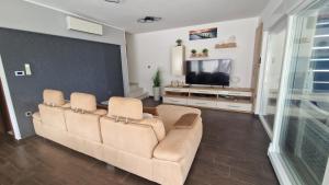 a living room with a couch and a flat screen tv at Villa Gina in Sevid