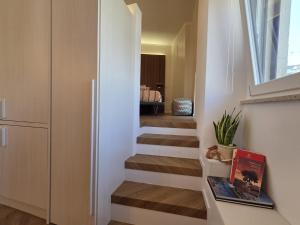 a staircase in a house with a window and a room at La dimora del figulo in Rutigliano