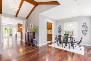 a dining room and living room with a table and chairs at Walk to Ventura Boulevard Pool & HotTub with PingPong & BBQ in Sherman Oaks