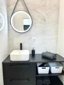 a bathroom with a sink and a mirror on a counter at Le 5, loc studio malouin in Saint Malo +5 photos
