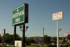 a street sign for the six mile infantry inn at Sherman Inn in Sherman