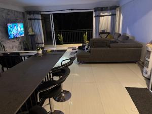 a living room with a couch and a table at StayLOG Peradeniya in Kandy