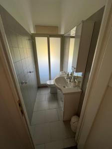 a bathroom with a sink and a toilet at La Rosa dello Jonio in Giarre