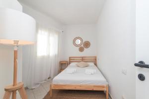 a bedroom with a bed and a clock on the wall at Alba Azzurra in San Pasquale