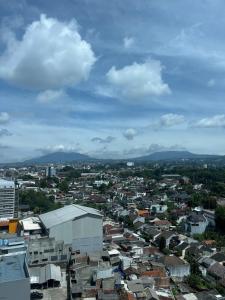 a view of a city with houses and buildings at 2BR Setiabudi Fresh Look, Mountain View in Bandung