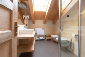 a bathroom with a sink and a toilet at Engadina Chalet in Livigno
