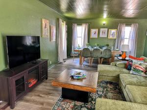 a living room with a couch and a television and a table at Condo 2BD2BAGrillLaundry-8PP-Pet Friendly in Russell