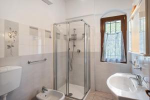 a bathroom with a shower and a toilet and a sink at Casa Rosmarino in Cisano sul Neva +22 photos