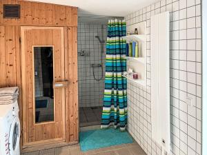 a shower in a bathroom with a shower curtain at Holiday Home Kapitänshaus Leo by Interhome in Leopoldshagen