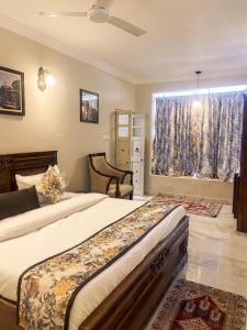 a bedroom with two beds and a window at Dareecha in Jodhpur