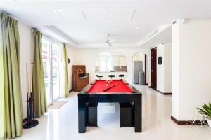 a billiard room with a red pool table at Baan Kaja Villa by Lofty in Surin Beach