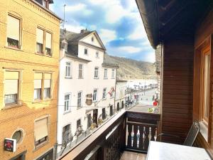 a balcony with a view of a street and buildings at Hotel zur Loreley Garni Mit großem Fahrradraum in Sankt Goar