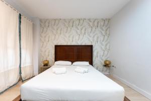 A bed or beds in a room at BHost - The Special One