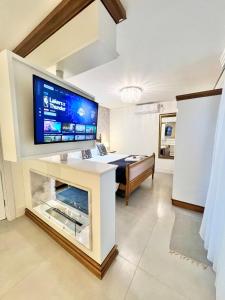 a living room with a large tv on top of a fireplace at Pousada Villa Vie in Gramado