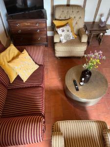 a living room with two chairs and a table at Park Farm in Thornham Magna
