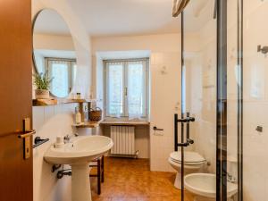a bathroom with a sink and a toilet and a shower at Holiday Home Castello by Interhome in Dervio