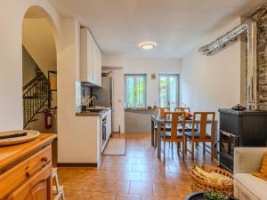 a kitchen and living room with a table and chairs at Holiday Home Castello by Interhome in Dervio +44 photos
